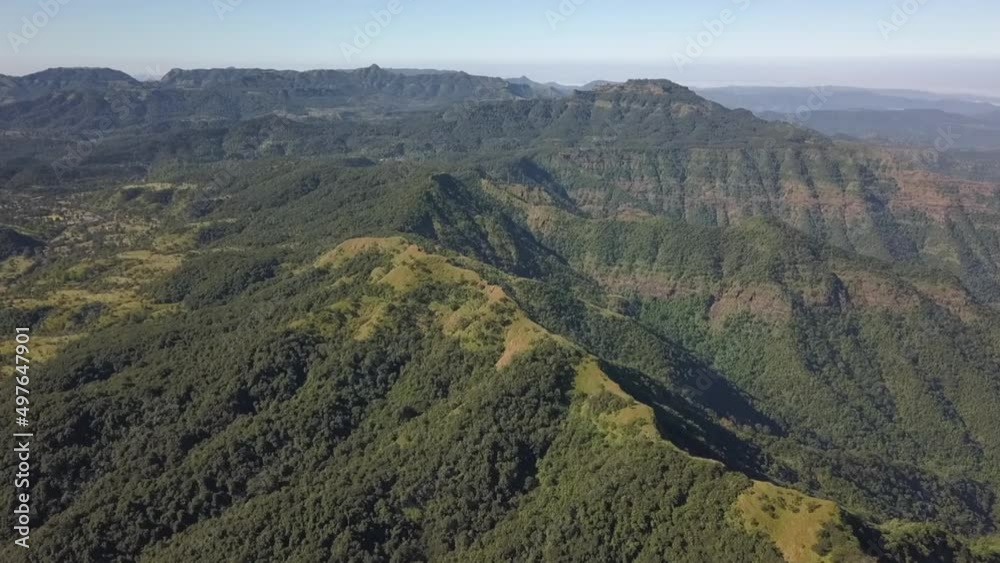 Aerial view of lush green low mountain range with meadow ridges Aerial view of lush green low mountain range with meadow ridges