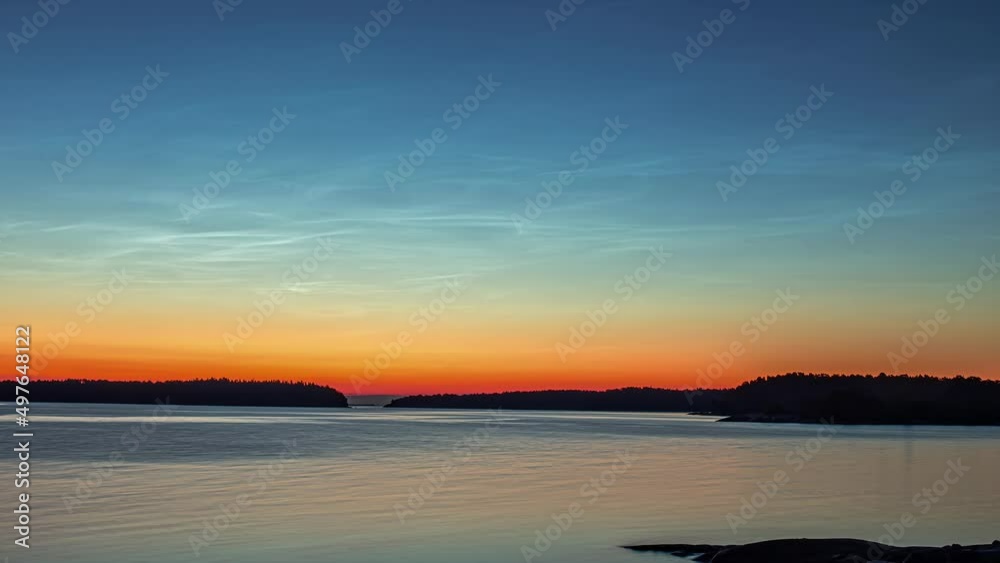Static view sun rising over the river water along the shore in timelapse. Static view sun rising over the river water along the shore in timelapse.