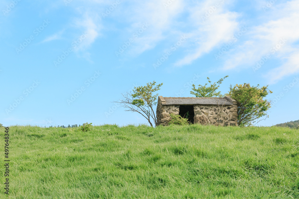 A small stone house on a hill. A small stone house on a hill.