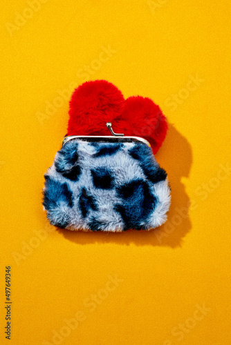 red plush heart in an animal print coin purse