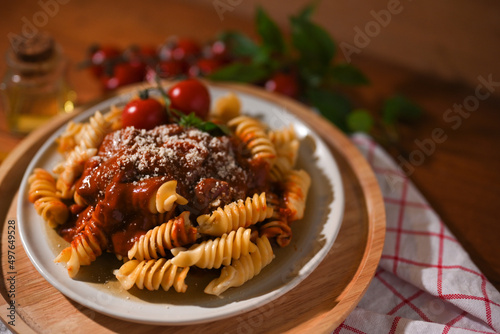 A plate of Italian Fusilli pasta with tomato sauce and parmesan cheese.