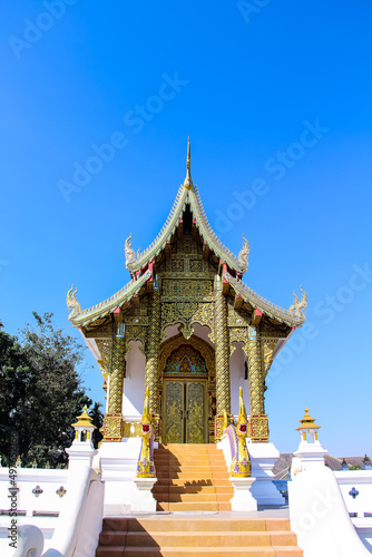 Beautiful Thai chapel temple on bright blue sky background and vast space