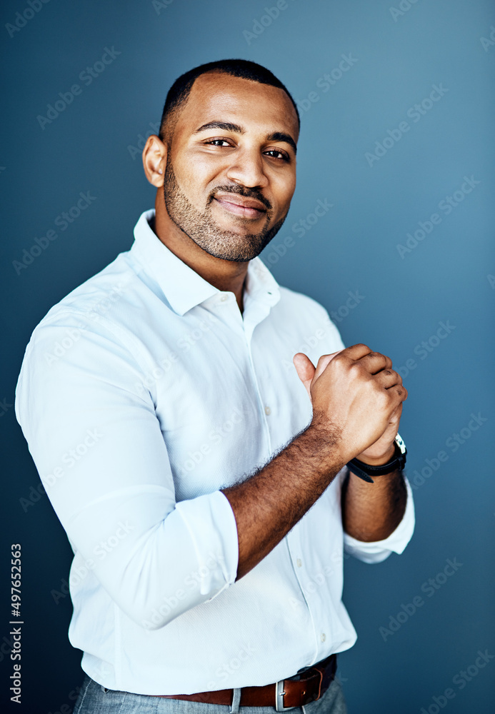 On to bigger and better things. Cropped portrait of a handsome young businessman standing alone against a studio background with his hands clasped together. On to bigger and better things. Cropped portrait of a handsome young businessman standing alone against a studio background with his hands clasped together.