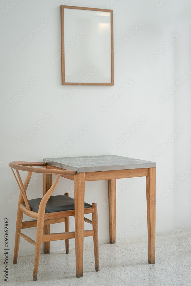 Classic set of wooden chairs and table with wooden blank space photo frame interior on the white marble floor for modern house and decoration living room. Classic set of wooden chairs and table with wooden blank space photo frame interior on the white marble floor for modern house and decoration living room.
