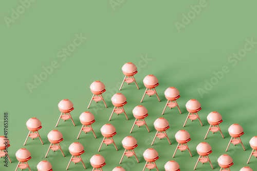 Pink barbeque grill on a green background