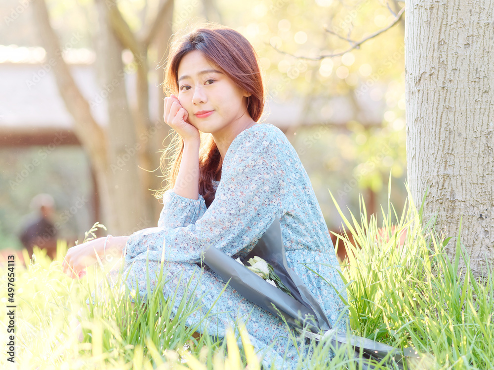 Portrait of elegant Chinese girl in dress enjoy carefree time in forest park in sunny day. Outdoor fashion portrait of glamour young Chinese cheerful stylish woman. Portrait of elegant Chinese girl in dress enjoy carefree time in forest park in sunny day. Outdoor fashion portrait of glamour young Chinese cheerful stylish woman.