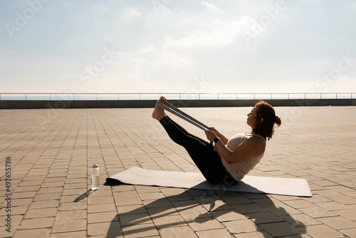 curvy  woman practicing yoga