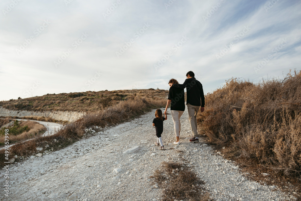 © Irina Polonina/Stocksy - Family with child on walk. © Irina Polonina/Stocksy - Family with child on walk.