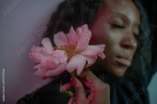 a peony flower on the background of a girl holding it photo