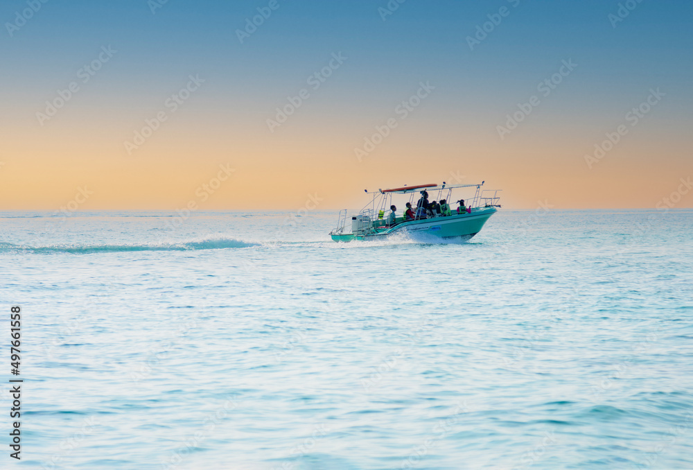 speedboat takes tourists back from diving at Samae San Island, Chonburi Province.