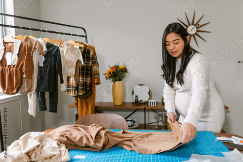 Pregnant business owner working at home