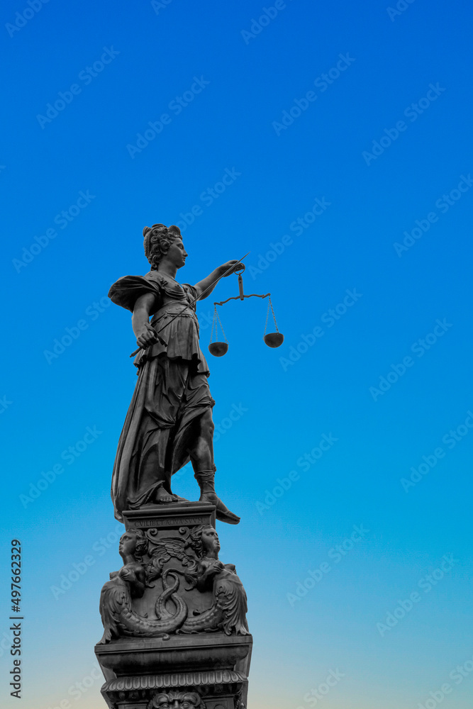 silhouette of Lady Justice at the fountain at Romerberg in Frankfurt