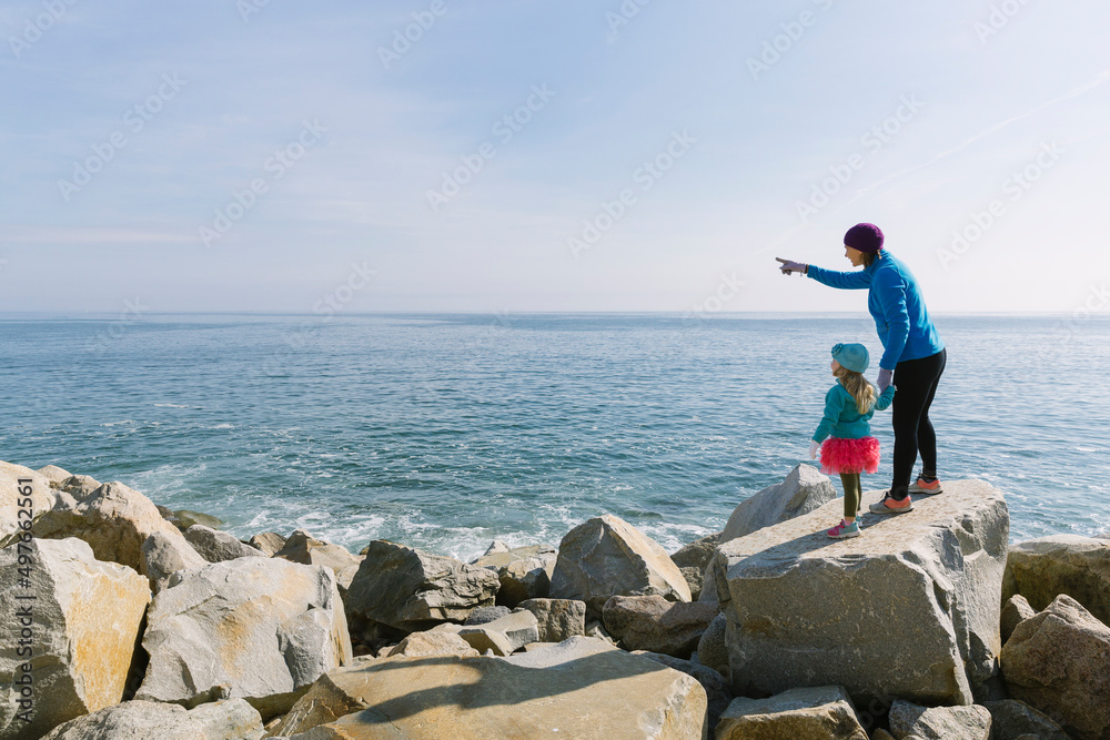 Winter family lifestyle with Child and mother at coast Winter family lifestyle with Child and mother at coast