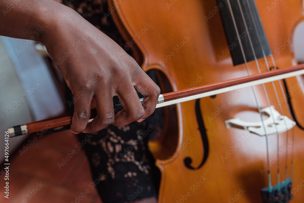 Close-up of a girl's hand playing cello Close-up of a girl's hand playing cello