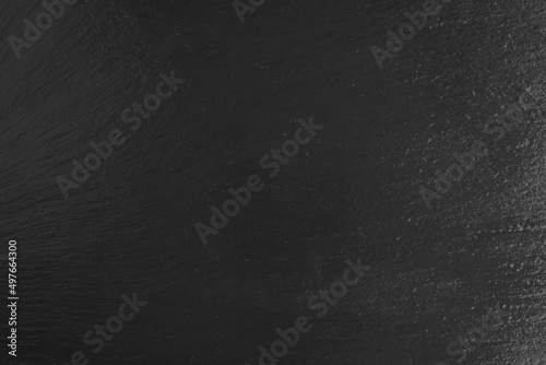 Black slate surface background. Dark grey natural stone texture