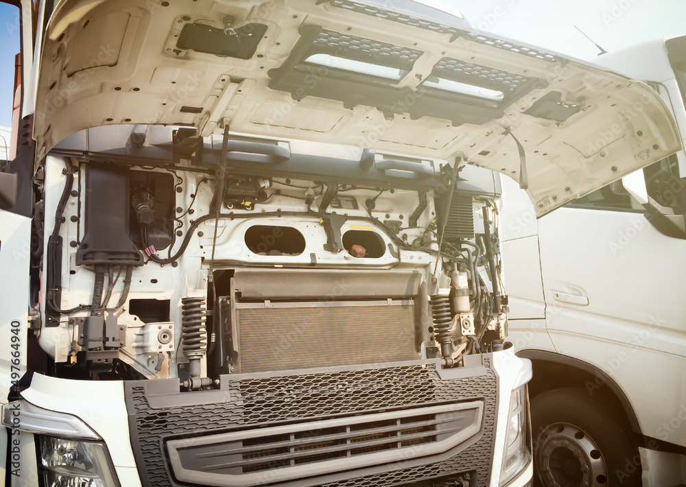 Front of Semi Truck Engine Opening Hood for Maintenance and Repairing. Diesel Engine Truck. Auto Repair Service Shop. Front of Semi Truck Engine Opening Hood for Maintenance and Repairing. Diesel Engine Truck. Auto Repair Service Shop.