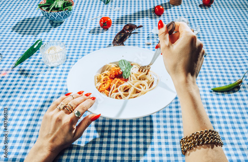 Female Hands twisting bolognese spaghetti with fork.
