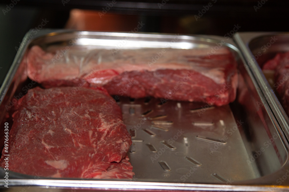 A rib-eye cut of good marbled beef lies in the restaurant, waiting to be cooked A rib-eye cut of good marbled beef lies in the restaurant, waiting to be cooked