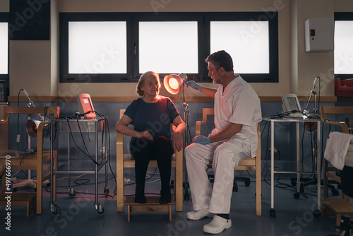 Patient and doctor during infrared therapy photo