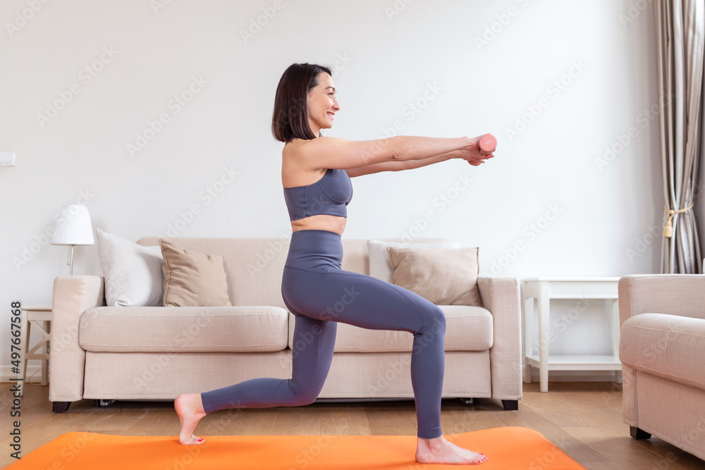 Asian woman exercise with dumbbells at home. Happy female doing arm workout using dumbbells