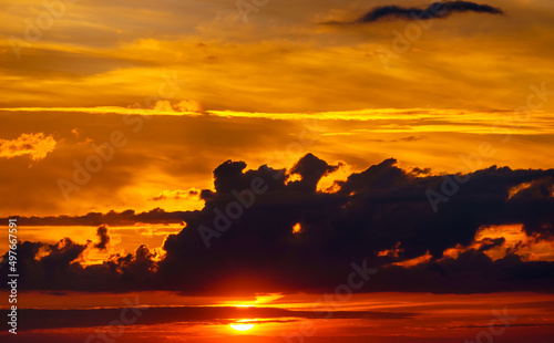 beautiful dramatic sunset sky, bright sunlight and dark silhouette of clouds as a background © soleg