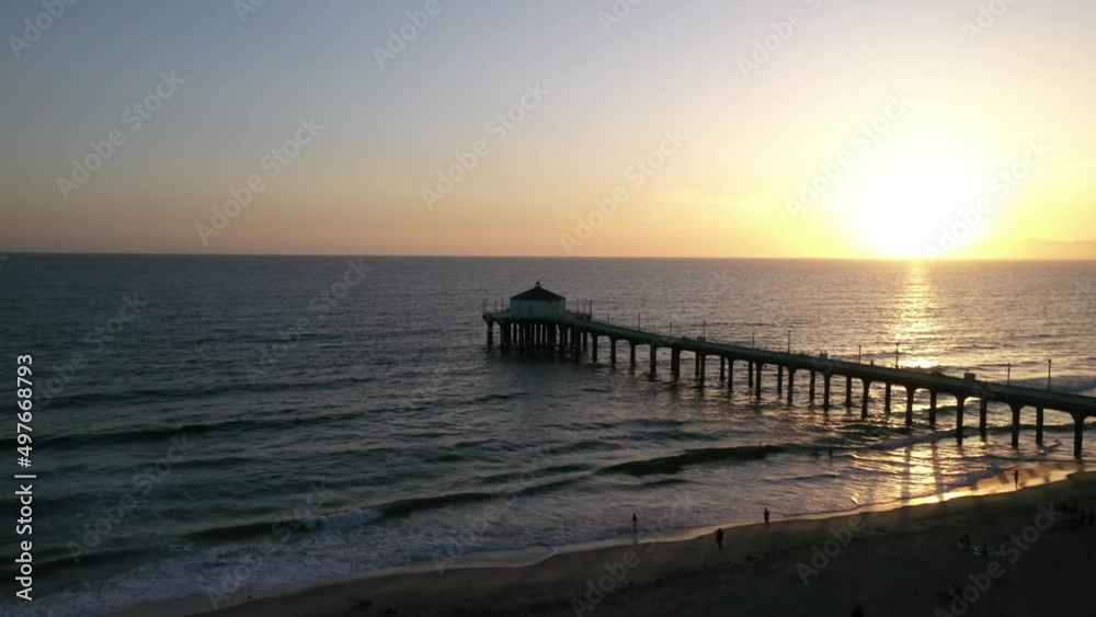 Warm Sunset Sky Illuminated Through Pacific Ocean In Manhattan Beach Pier, California USA. Wide Shot Warm Sunset Sky Illuminated Through Pacific Ocean In Manhattan Beach Pier, California USA. Wide Shot