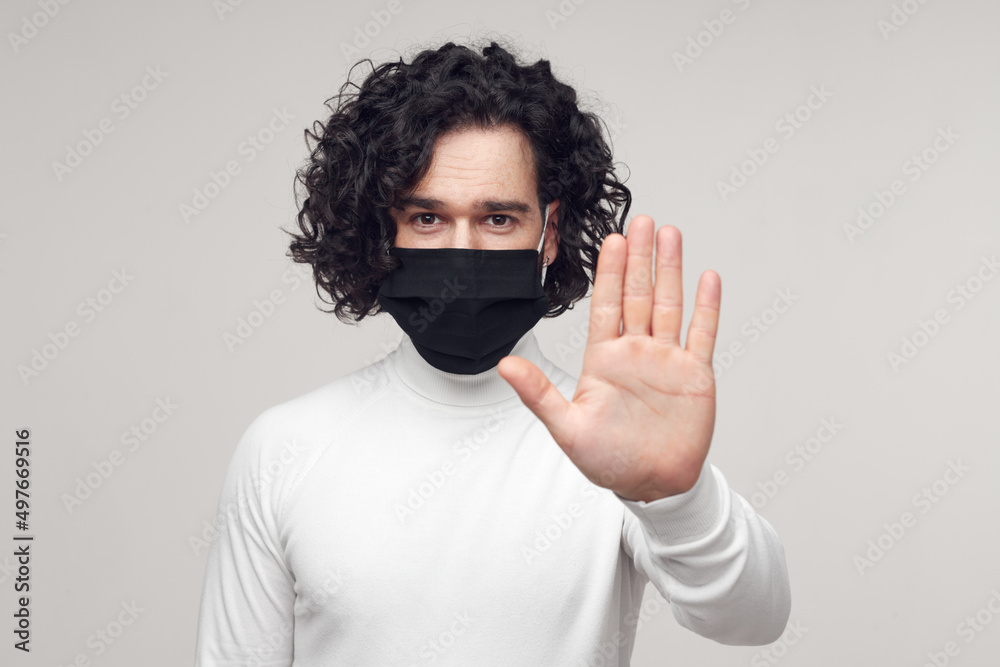 Man in face mask gesturing stop for keeping social distance Man in face mask gesturing stop for keeping social distance