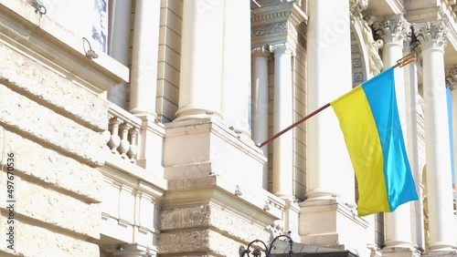 blue and yellow Ukrainian flag near building  Lviv during war