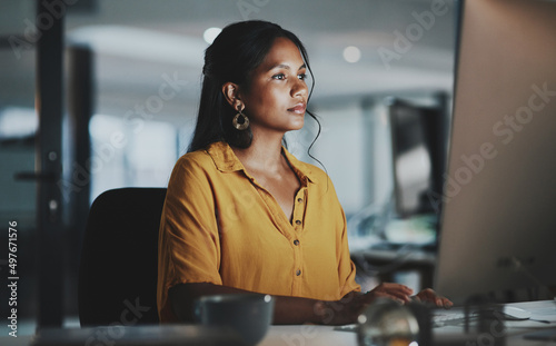 Without some effort, you wont be able to prosper. Shot of a young businesswoman working on a computer in an office at night.