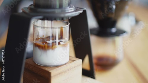 drop of espresso shot on chilled milk, home brewing process 