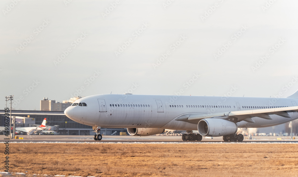 Airbus A330 taking off from the international airport. Cargo white aircraft without airline's livery and logo on the runway