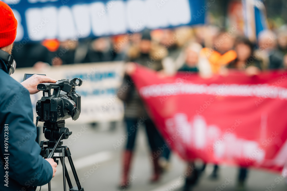 Making news, media cameraman at a public protest Stock Photo Adobe Stock