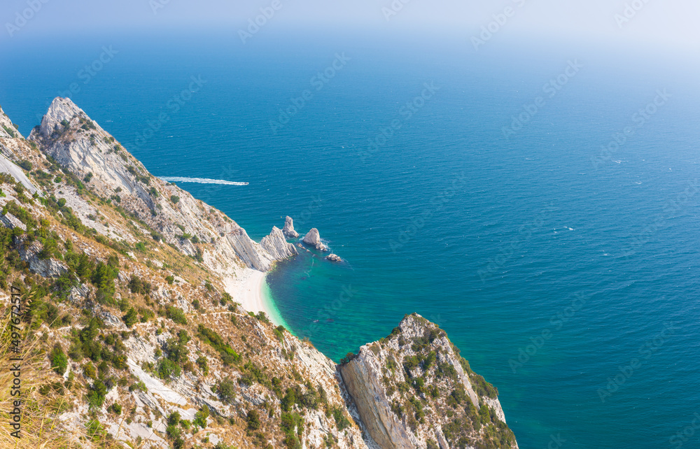 The beach of the two sisters view from above unique bay in Conero natural park dramatic coast headland rock cliff adriatic sea Italy turquoise transparent water