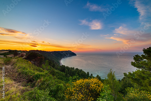 Sunset landscape Conero natural park dramatic coast headland rocky cliff adriatic sea beautiful sky colorful horizon, tourism destination Italy