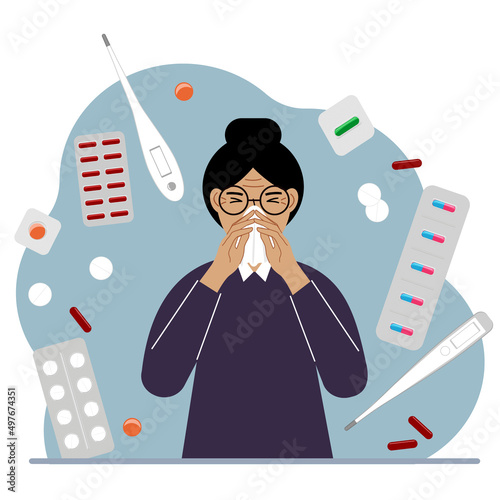 A woman covers his nose with his hands with a handkerchief. The concept of a cold person, seasonal allergies. Lots of medicines and thermometers.