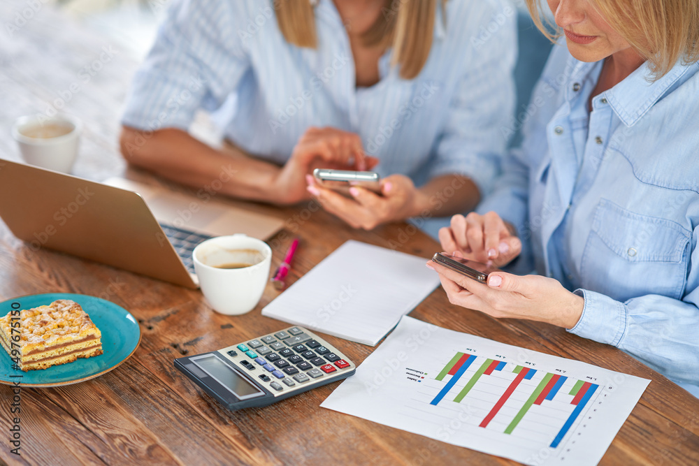 Two girl friends or lgbt couple with computer and invoice Two girl friends or lgbt couple with computer and invoice