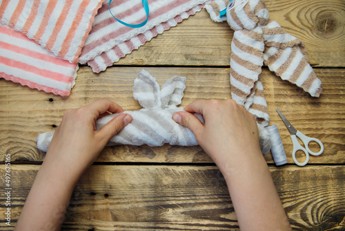 How to make an Easter bunny. Materials for toys towel, scissors, thread. DIY concept. Step-by-step photo instruction. Step 3. Fold the towel into a thin strip.