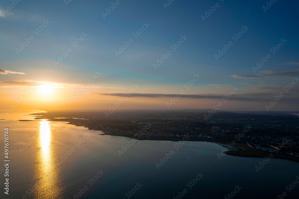 Sunset over Galway bay, Ireland. Beautiful blue sky and ocean and warm sun. Irish landscape. Aerial view