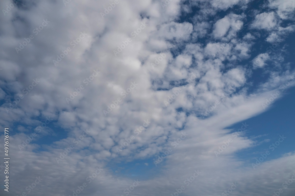 Naklejka premium White fluffy clouds on blue sky. Nature background.