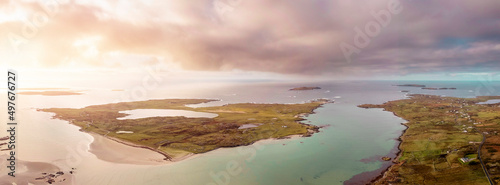 Aerial view on Omey island and beach. County Galway, Ireland. Place of horse racing in summer . Panorama image. High tide. Cloudy sky. Beautiful Irish nature landscape
