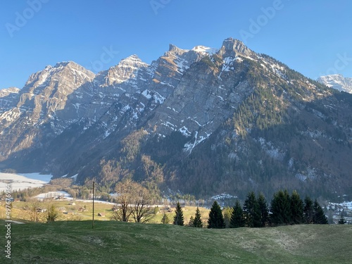 The alpine mountain range Glärnisch in the Swiss massif of Glarus alps and over the Klöntalersee reservoir lake (Kloentalersee or Klontaler lake) - Canton of Glarus, Switzerland (Schweiz) photo