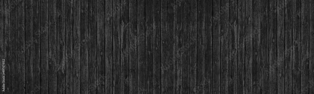 Naklejka premium Old black knotted wooden board wide panoramic texture. Dark gray rough wood plank long backdrop. Large abstract background