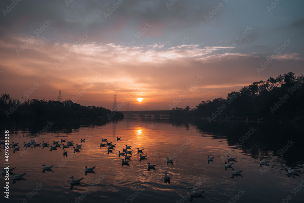Naklejka premium sunset over the river