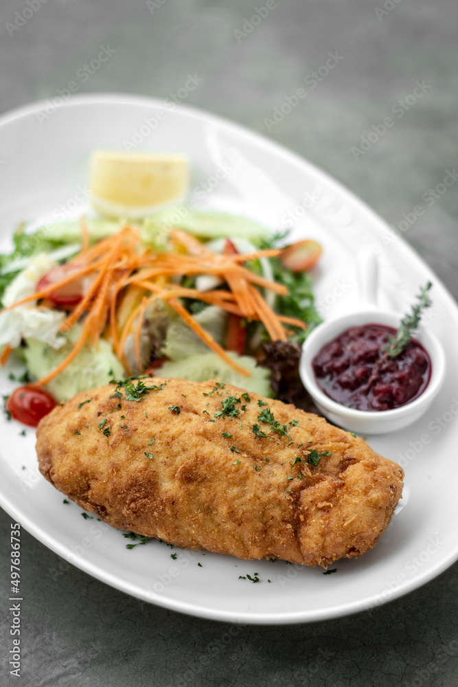 chicken cordon bleu meal with salad in french restaurant chicken cordon bleu meal with salad in french restaurant