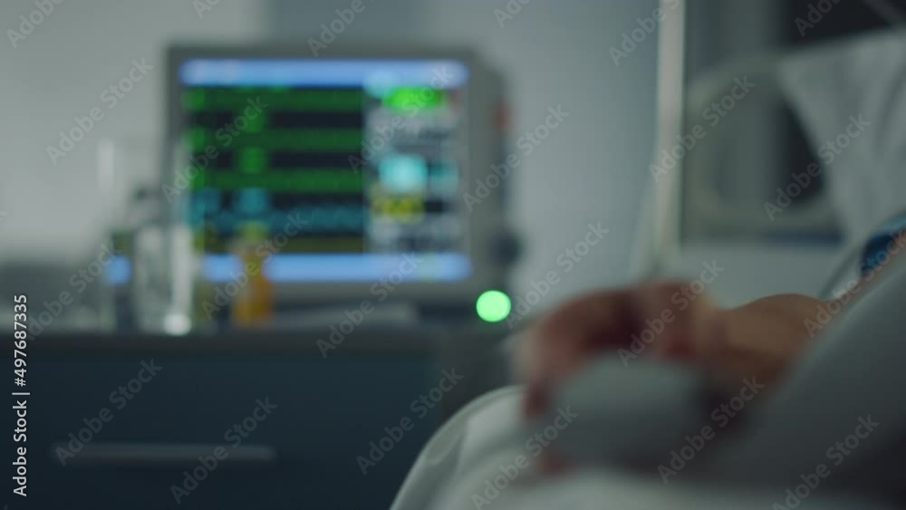 Heart rate monitor showing vital signs. Pulse oximeter hand in hospital close up