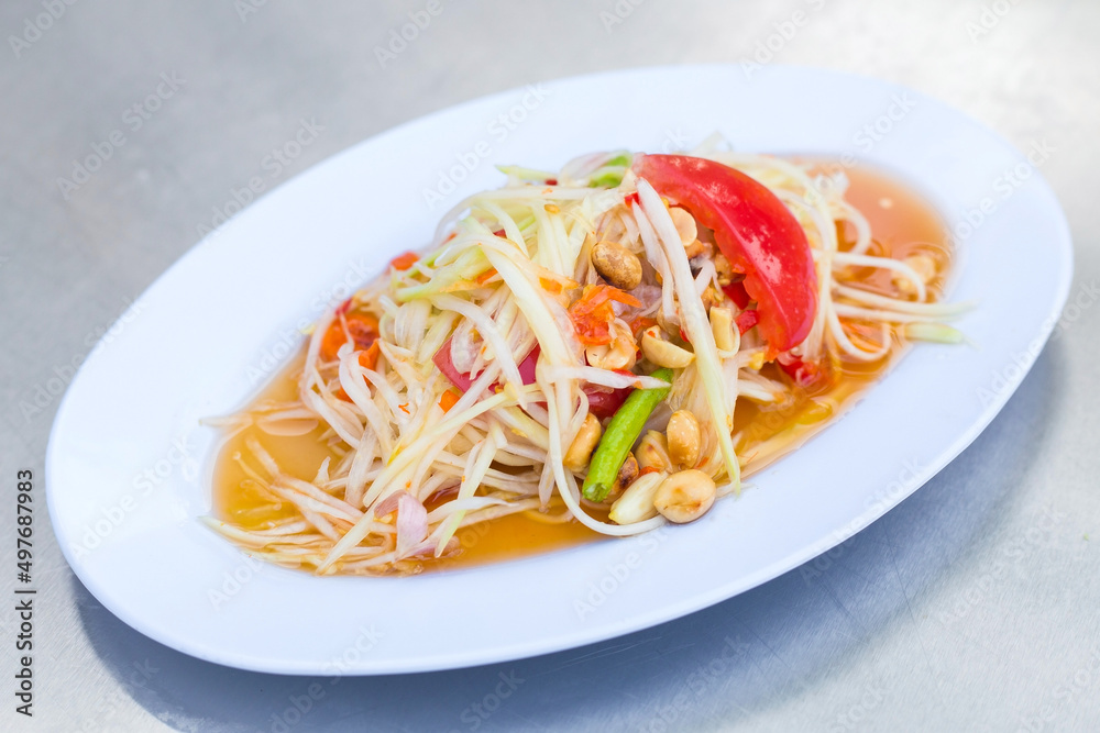 Papaya salad is a spicy salad made from shredded unripe papaya. Originating from ethnic Lao people, it is also eaten throughout Southeast Asia. It is Thai style food. Papaya salad is a spicy salad made from shredded unripe papaya. Originating from ethnic Lao people, it is also eaten throughout Southeast Asia. It is Thai style food.