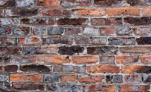 Brick wall in orange brown grunge brick background, Horizontal backdrop Abstract with broken bricks texture, English heritage old Vintage house facade wall with cracks and scratches vintage style