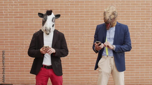 Two men disguised as animals use their cell phones. 