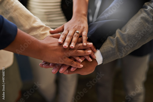 Encouraging employee motivation and inspiration as a team. Closeup shot of a group of unrecognizable businesspeople joining their hands together in a huddle.