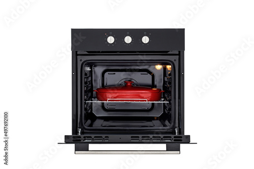 Black oven with open door and red baking dish front view isolated on white